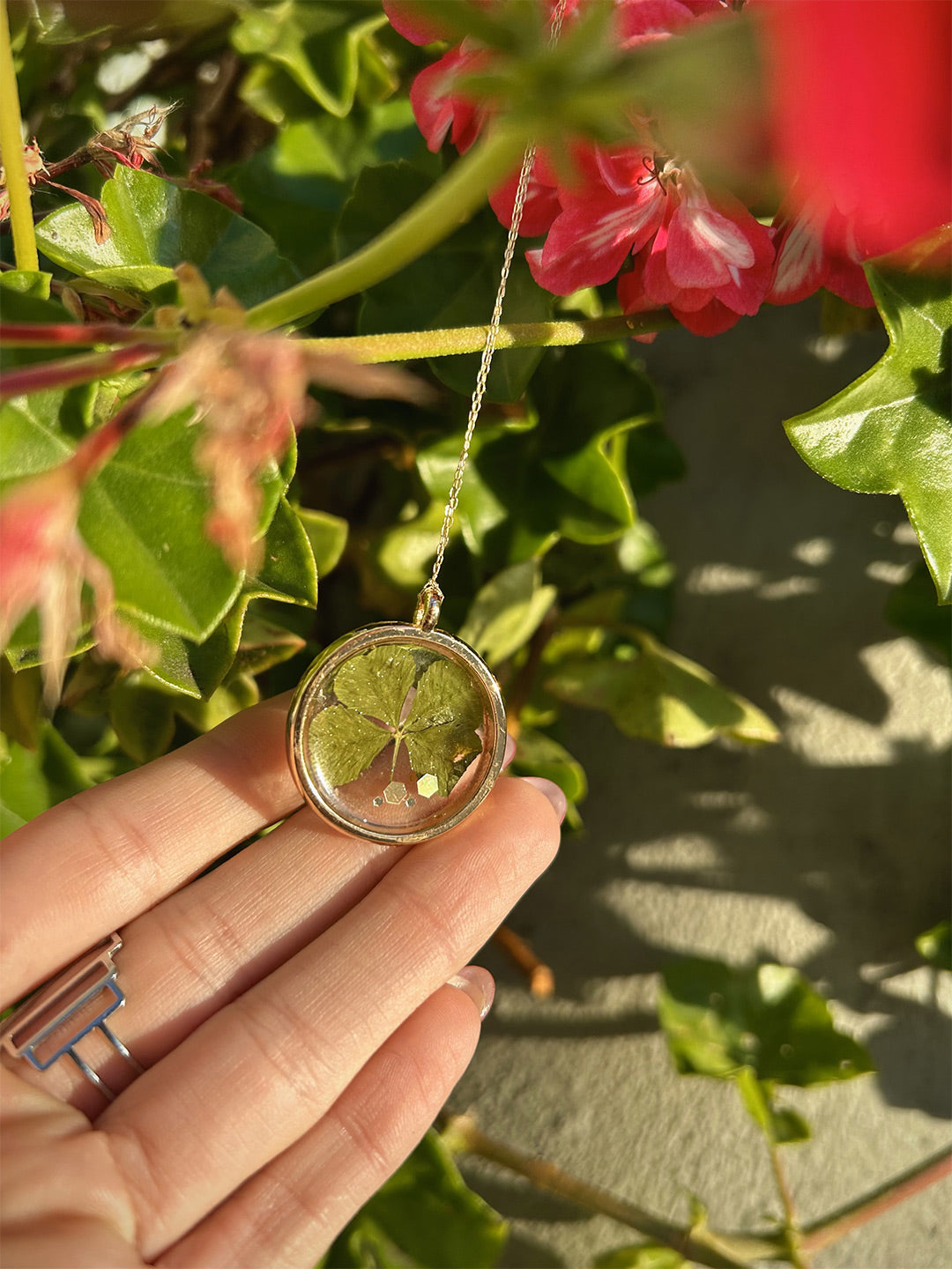 Clover Necklace in the sun shown with chain