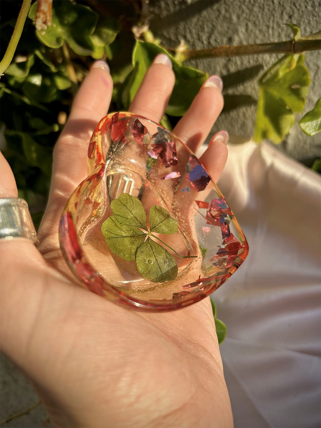 Fuchsia resin 4-leaf clover jewelry tray being held