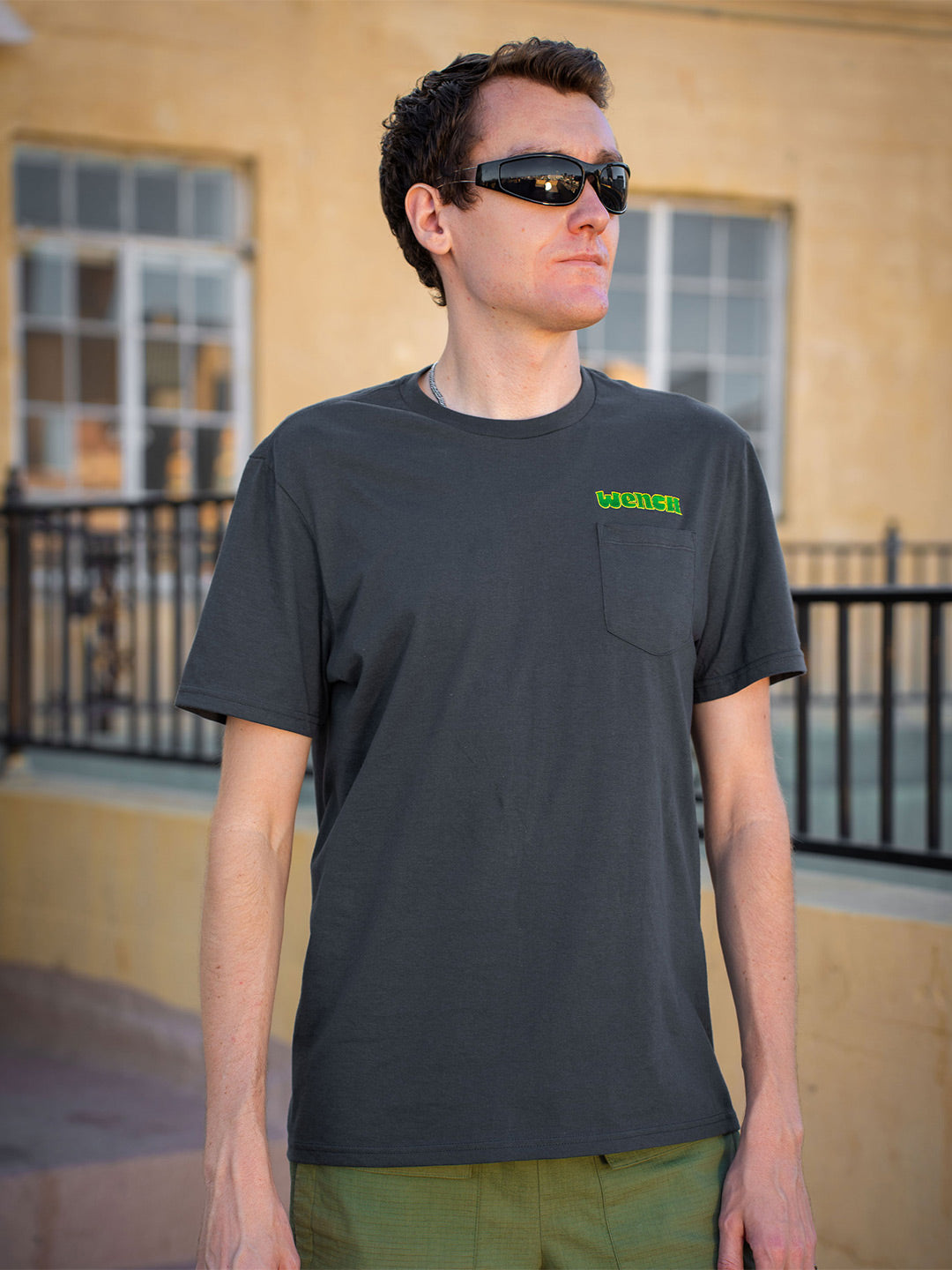 Wenches 2024 Unisex Pocket Tee Green Yellow Logo Front